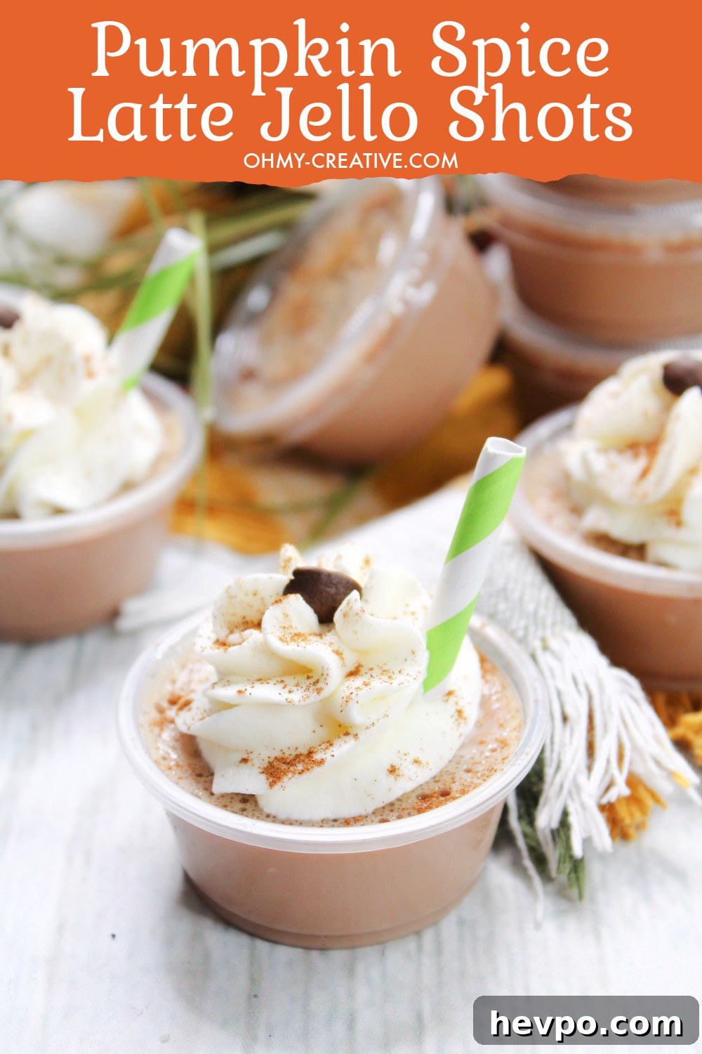 A tray of a yummy pumpkin spice latte jello shots topped with whipped cream and dusted with cinnamon!