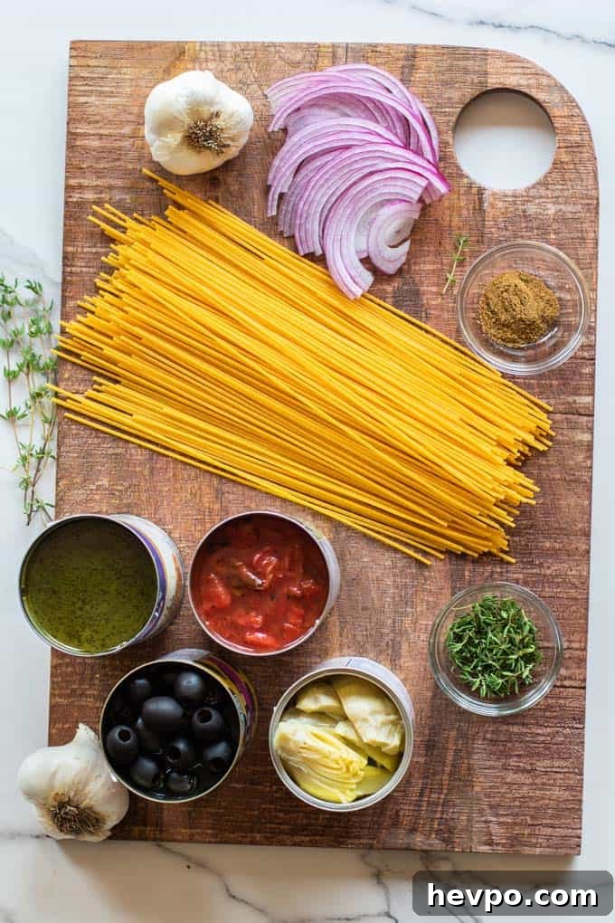 A cutting board with gluten free pasta and other one pot pasta ingredients.