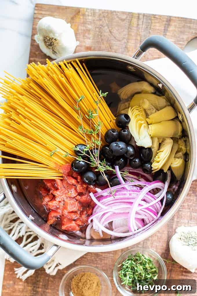 A pot filled with all the ingredients for this one pot pasta dish.