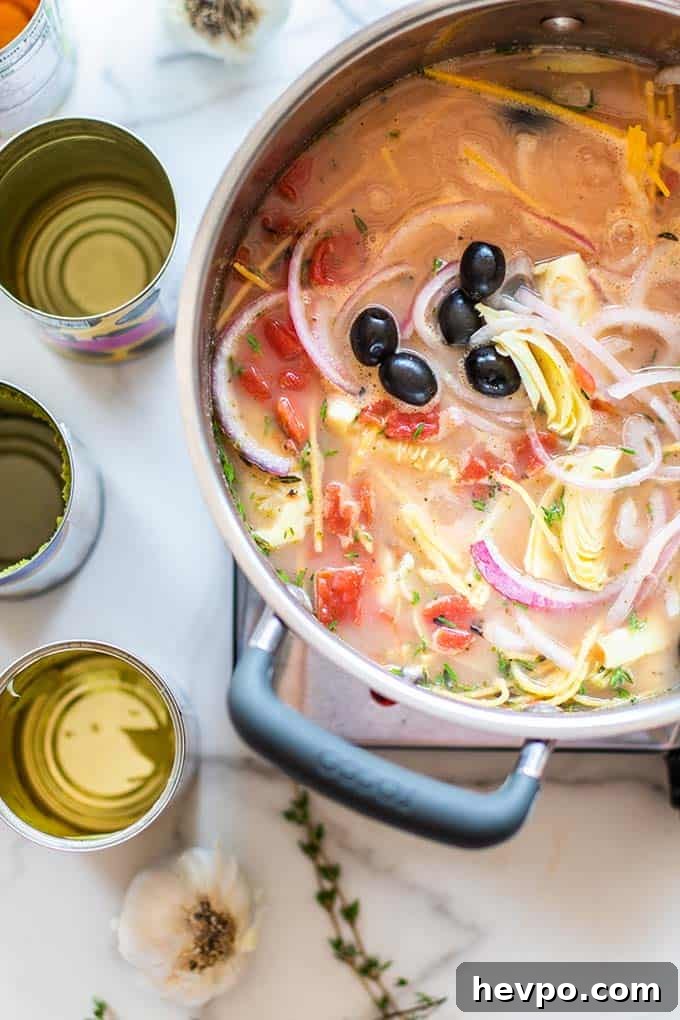 Pasta cooking in a broth.