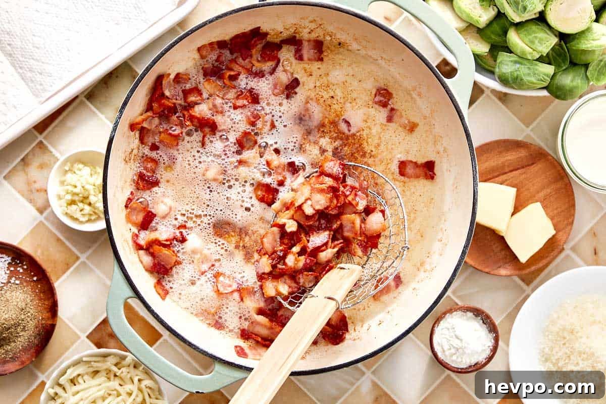 Crispy Bacon Brussels Sprouts Recipe: Roasted with Garlic and Honey 5 Crispy bacon cooking in a skillet