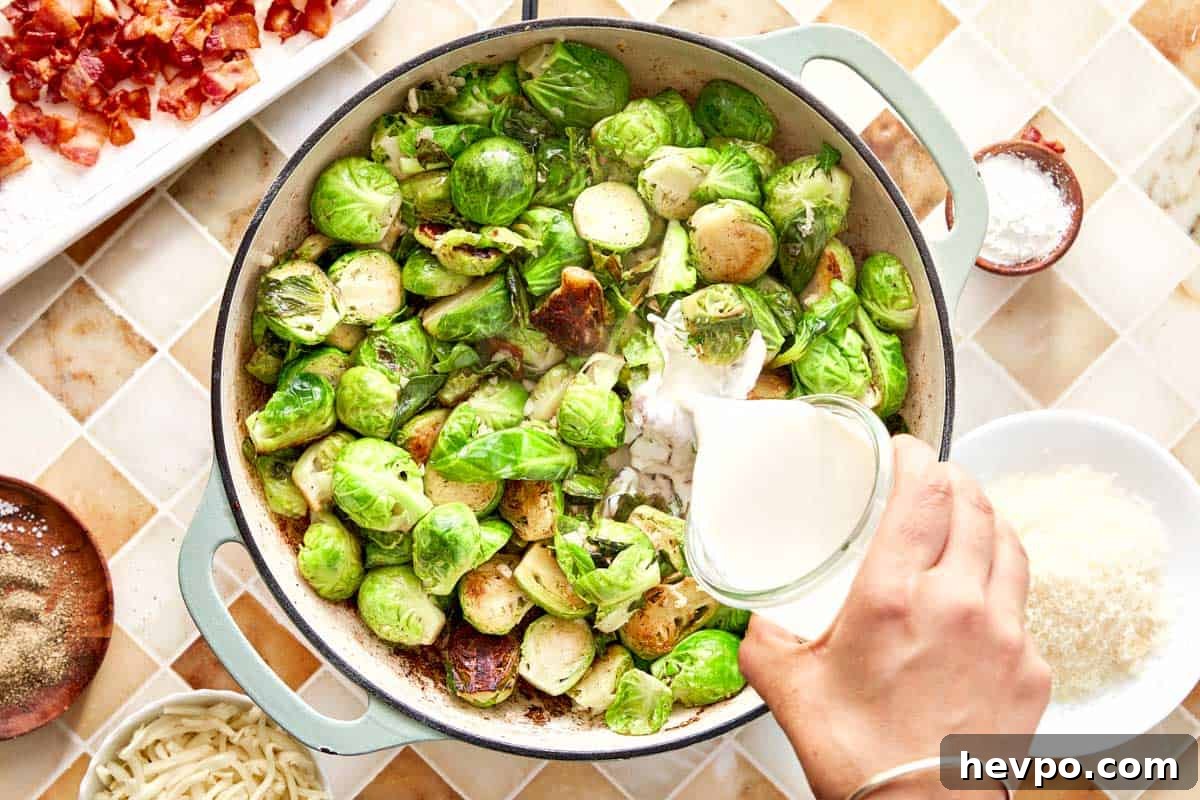Crispy Bacon Brussels Sprouts Recipe: Roasted with Garlic and Honey 9 Cream being poured over sautéed Brussels sprouts