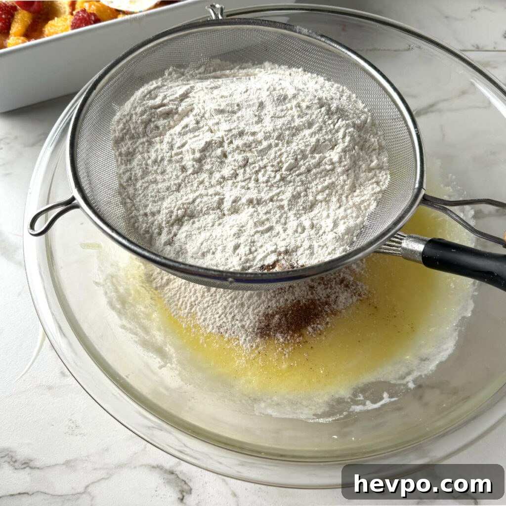 Raspberry and Peach Cobbler with Buttermilk Drop Biscuits 6 Adding the flour mixture to the spiced biscuit dough.
