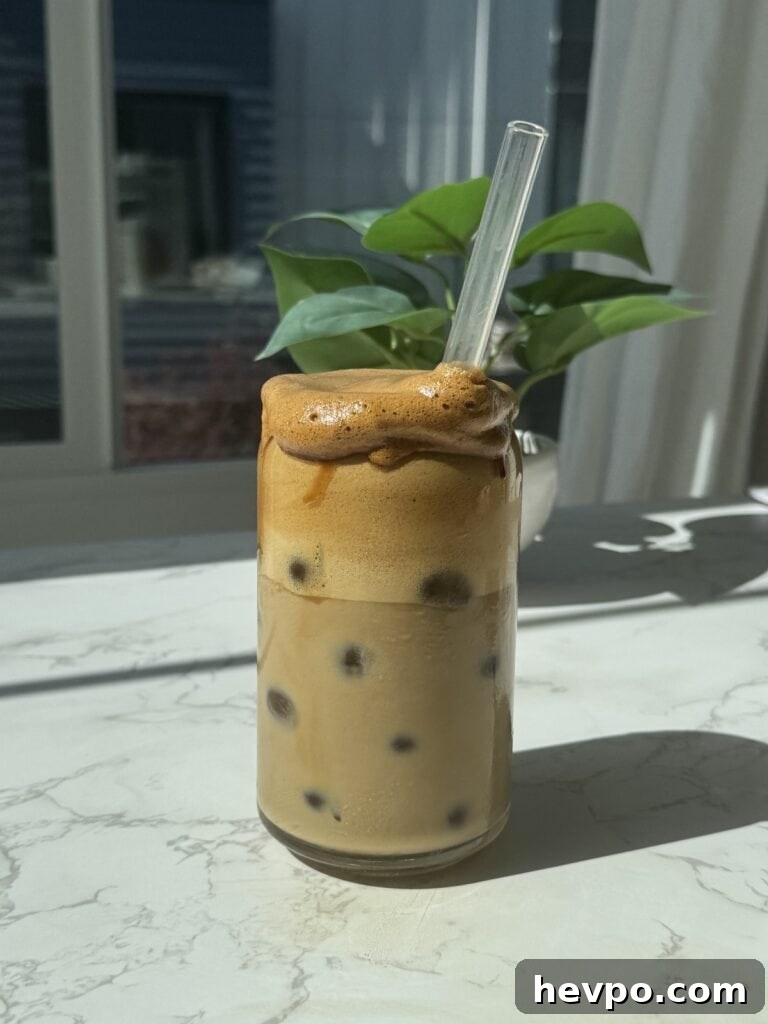 A cup filled with whipped honey coffee.