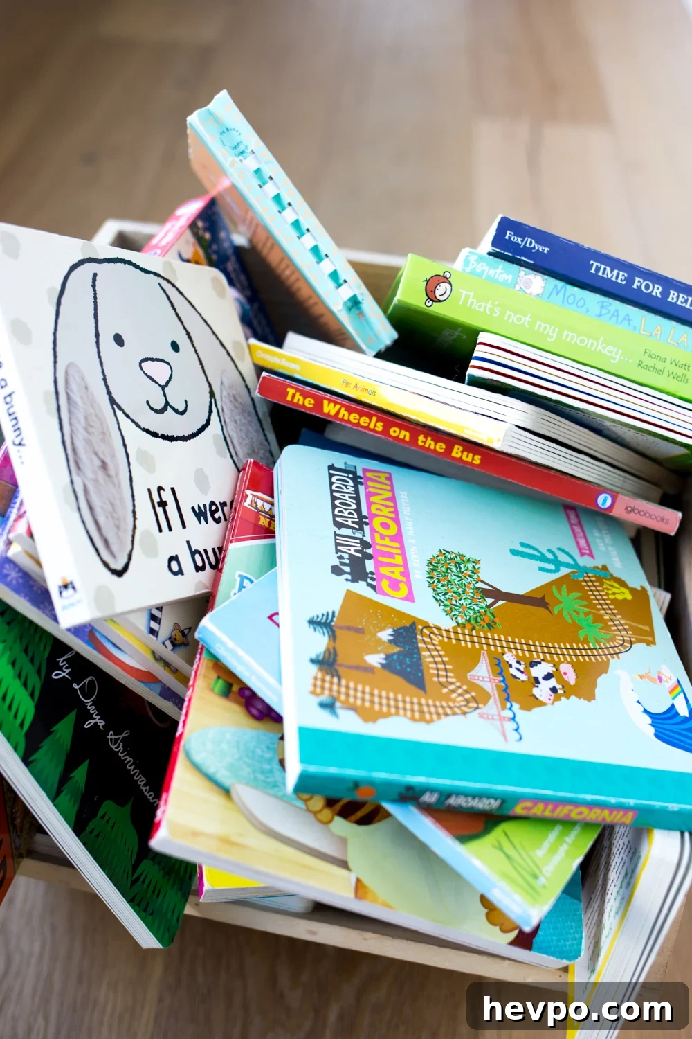 Declutter Kids' Books: Simple Steps to Organize Their Library 3 Pile of children's books in a wooden bin